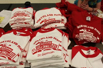 Northland Pines St. Germain Elementary School t-shirts in a pile on the table