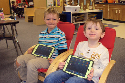 two students smiling with their ipads