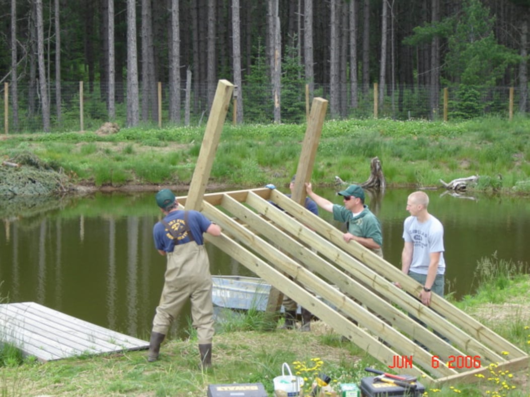 pier being constructed by pond