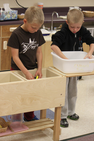 montessori students washing dishes after snack as part of their learning